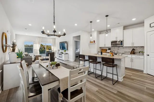 a view of kitchen with cabinets table and chairs