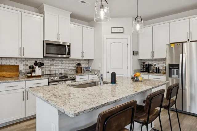 a kitchen with refrigerator a stove a sink and a refrigerator
