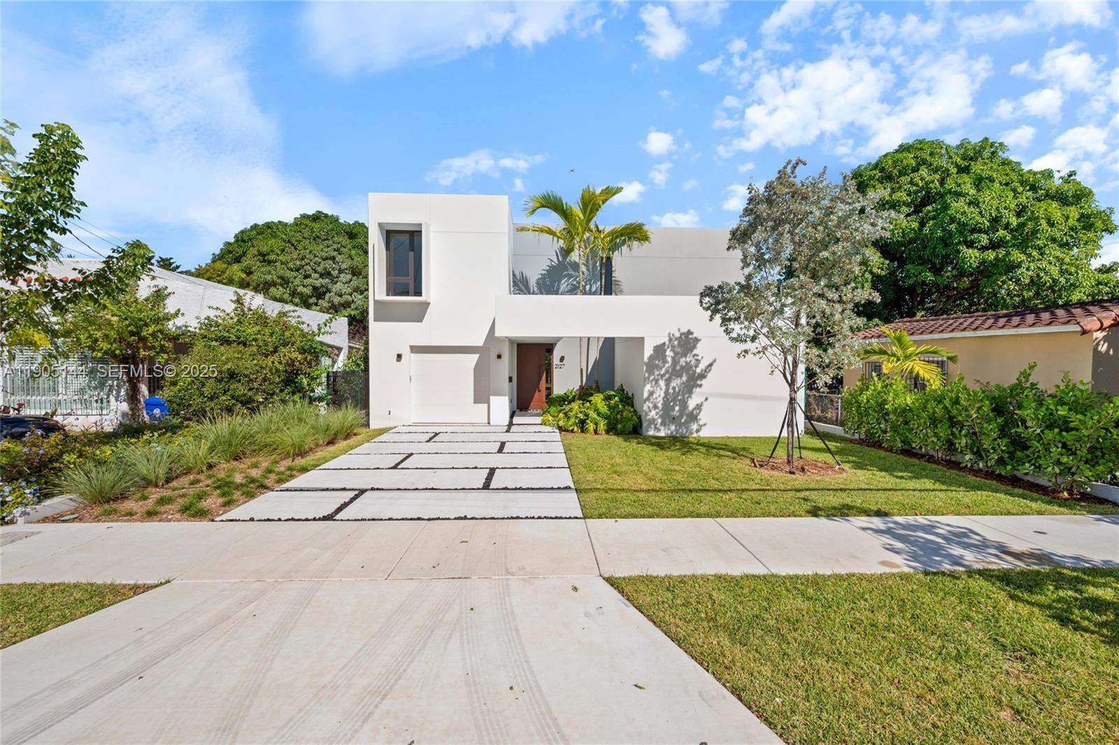 2127 Southwest 11th Terrace Miami, FL 33135 - Photo 1 of 28 a front view of a house with a yard and outdoor seating
