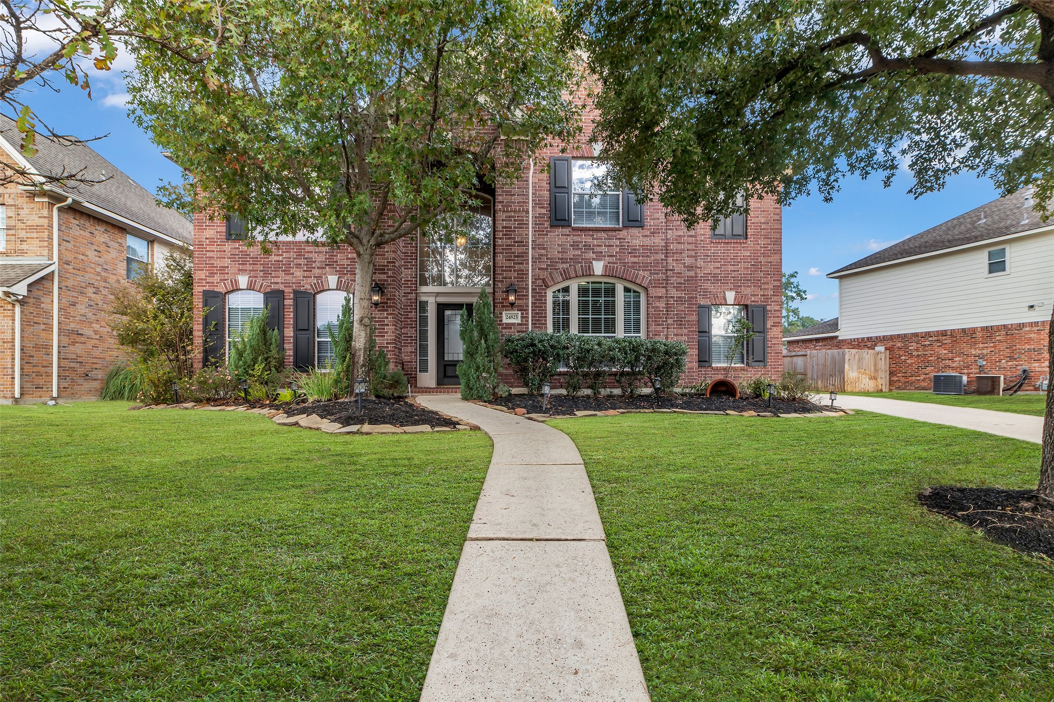 24823 Corbin Gate Drive Spring, TX 77389 - Photo 1 of 25 a front view of a house with a yard and trees