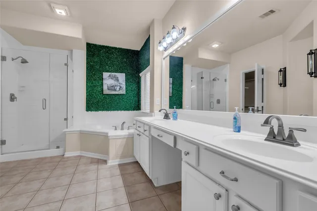 a bathroom with a sink a large mirror and a bathtub