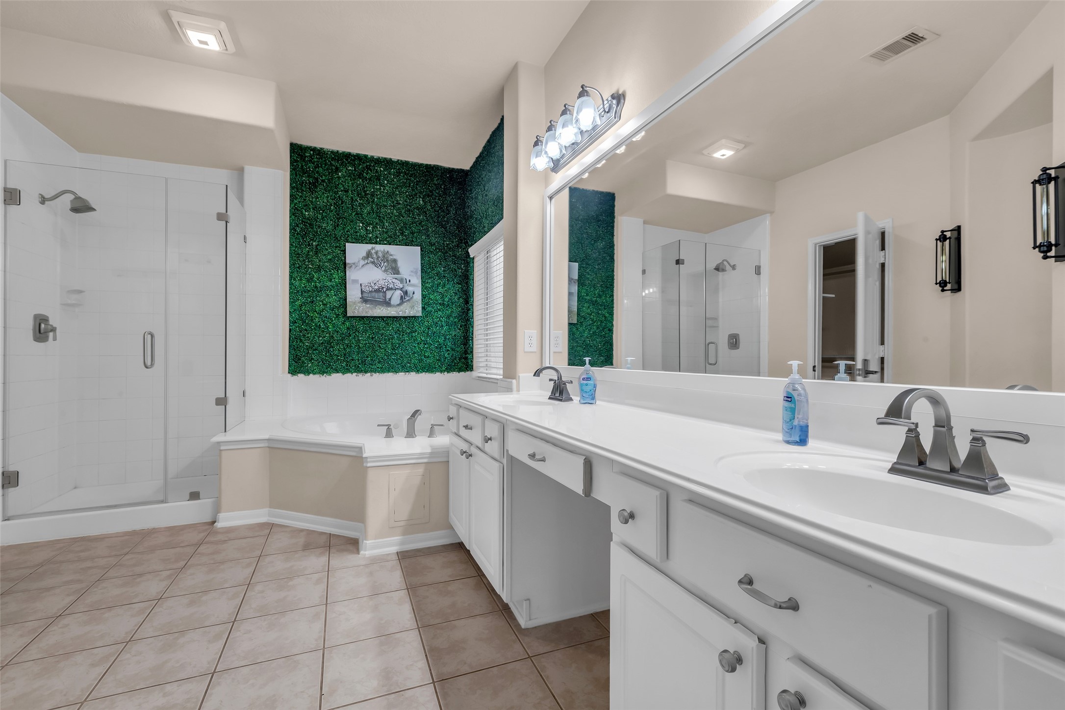 24823 Corbin Gate Drive Spring, TX 77389 - Photo 16 of 25 a bathroom with a sink a large mirror and a bathtub