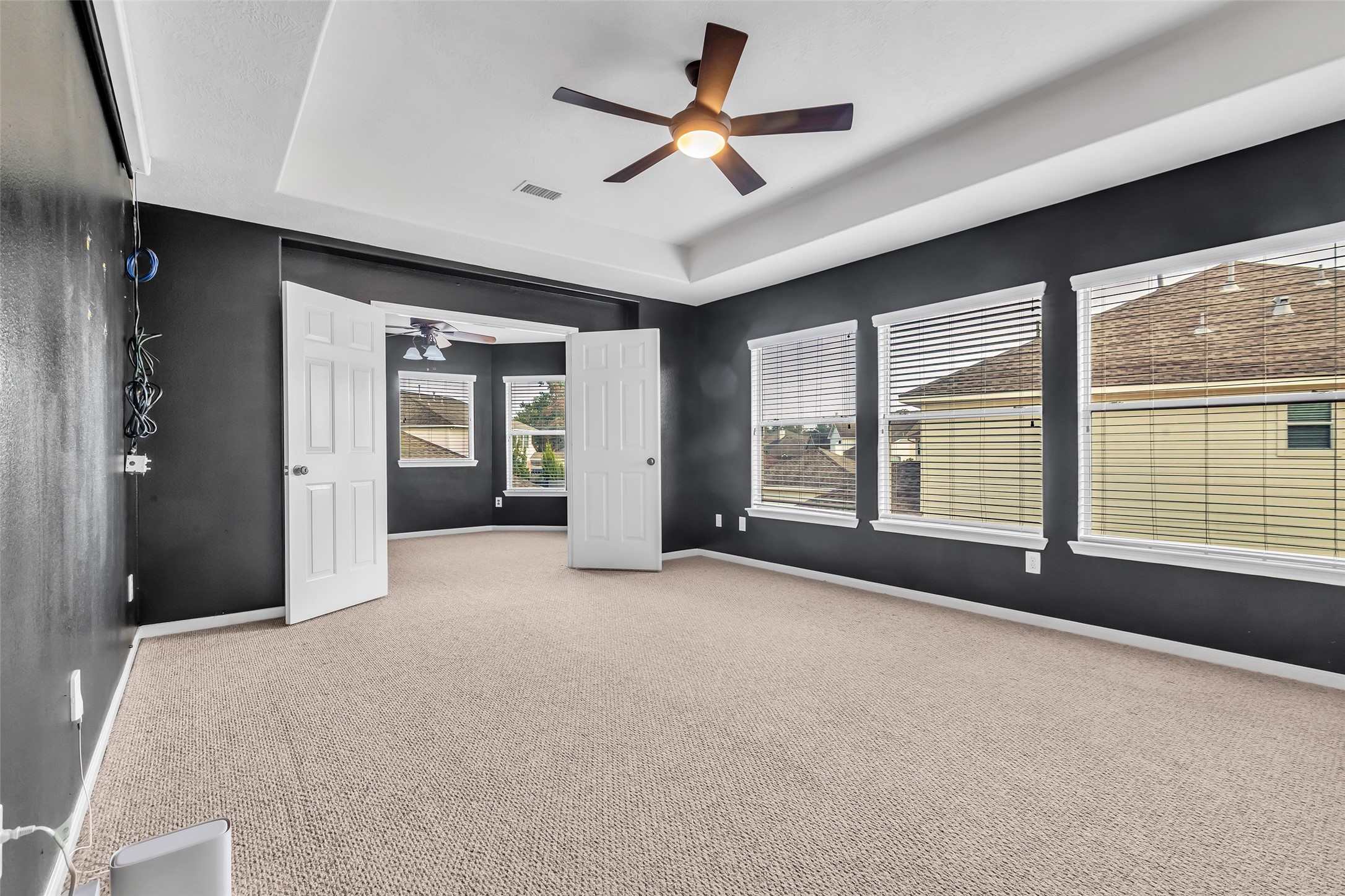 24823 Corbin Gate Drive Spring, TX 77389 - Photo 17 of 25 a view of a livingroom with a ceiling fan and windows
