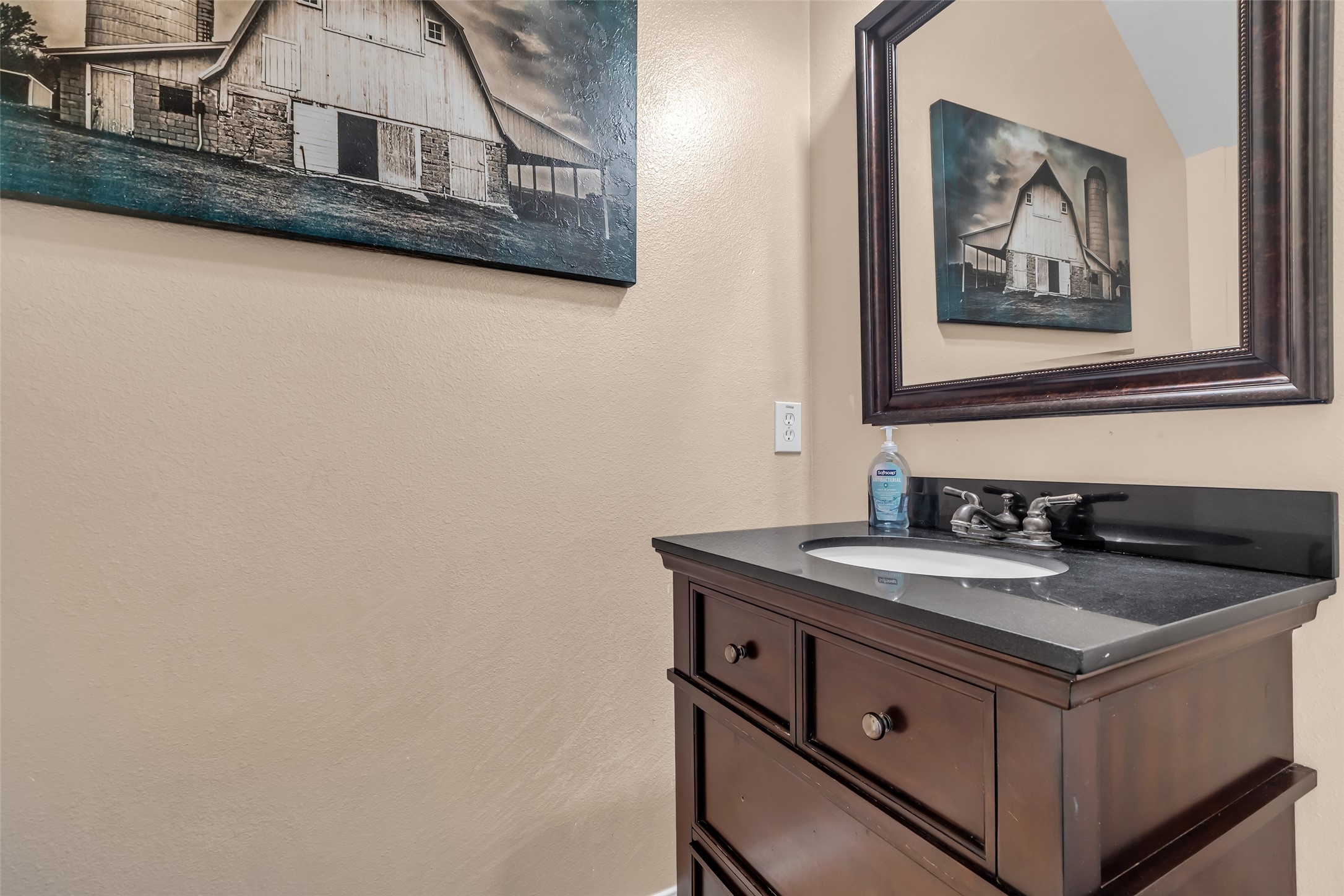24823 Corbin Gate Drive Spring, TX 77389 - Photo 4 of 25 a bathroom with a sink and a mirror