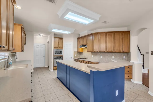 a kitchen with a sink cabinets and appliances