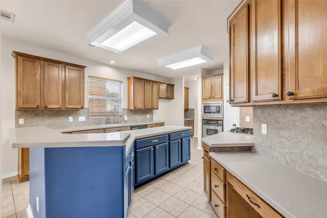 a kitchen with stainless steel appliances granite countertop a sink and cabinets