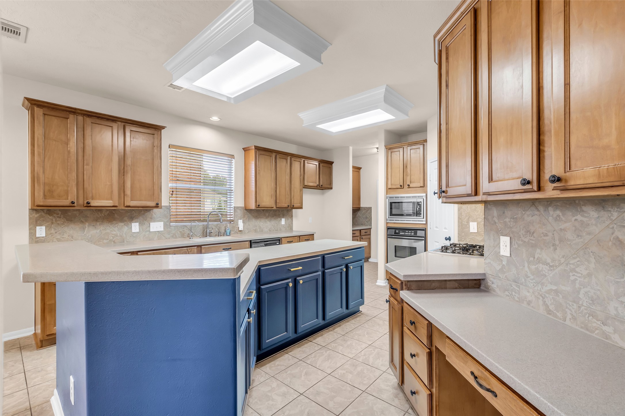 24823 Corbin Gate Drive Spring, TX 77389 - Photo 9 of 25 a kitchen with stainless steel appliances granite countertop a sink and cabinets