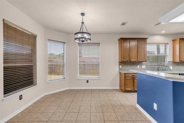 a view of a kitchen with granite countertop a sink dishwasher a stove and a refrigerator