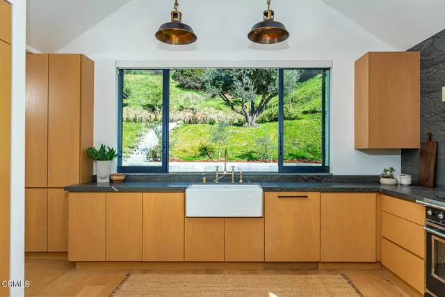 a kitchen with stainless steel appliances granite countertop a refrigerator and a stove top oven