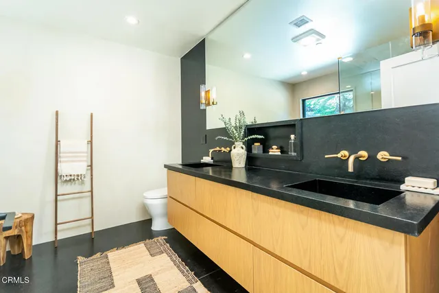 a bathroom with a tub a sink and mirror