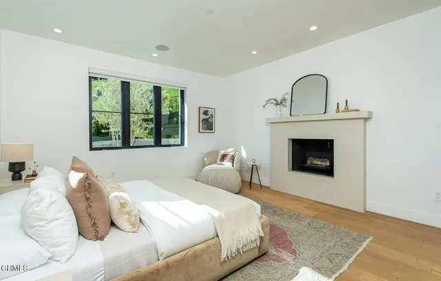 a bedroom with a bed and a fireplace