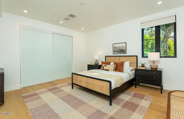 a spacious bedroom with a bed and a window