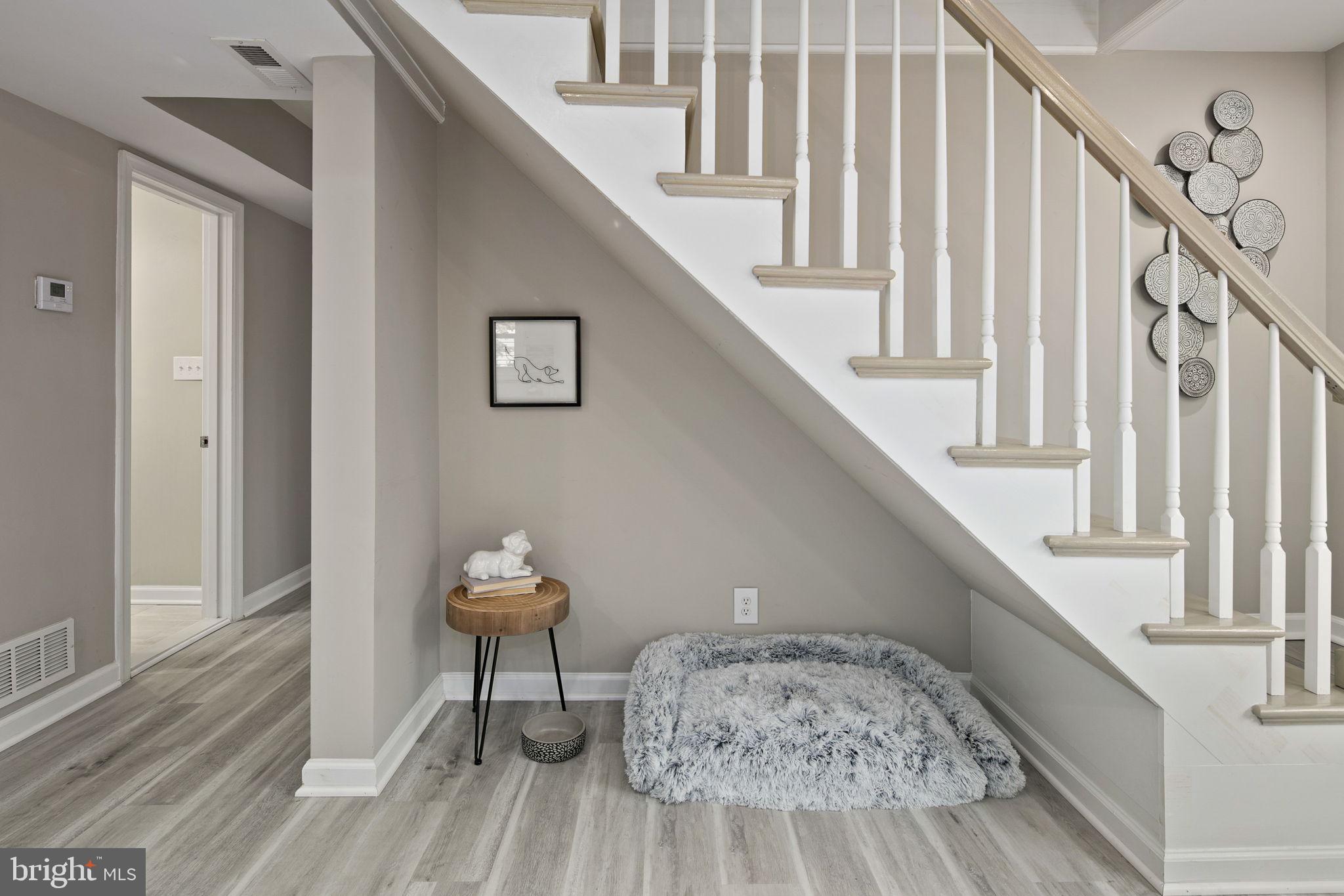 3424 Spring Drive Alexandria, VA 22306 - Photo 11 of 52 a hallway with stairs and a wooden floor
