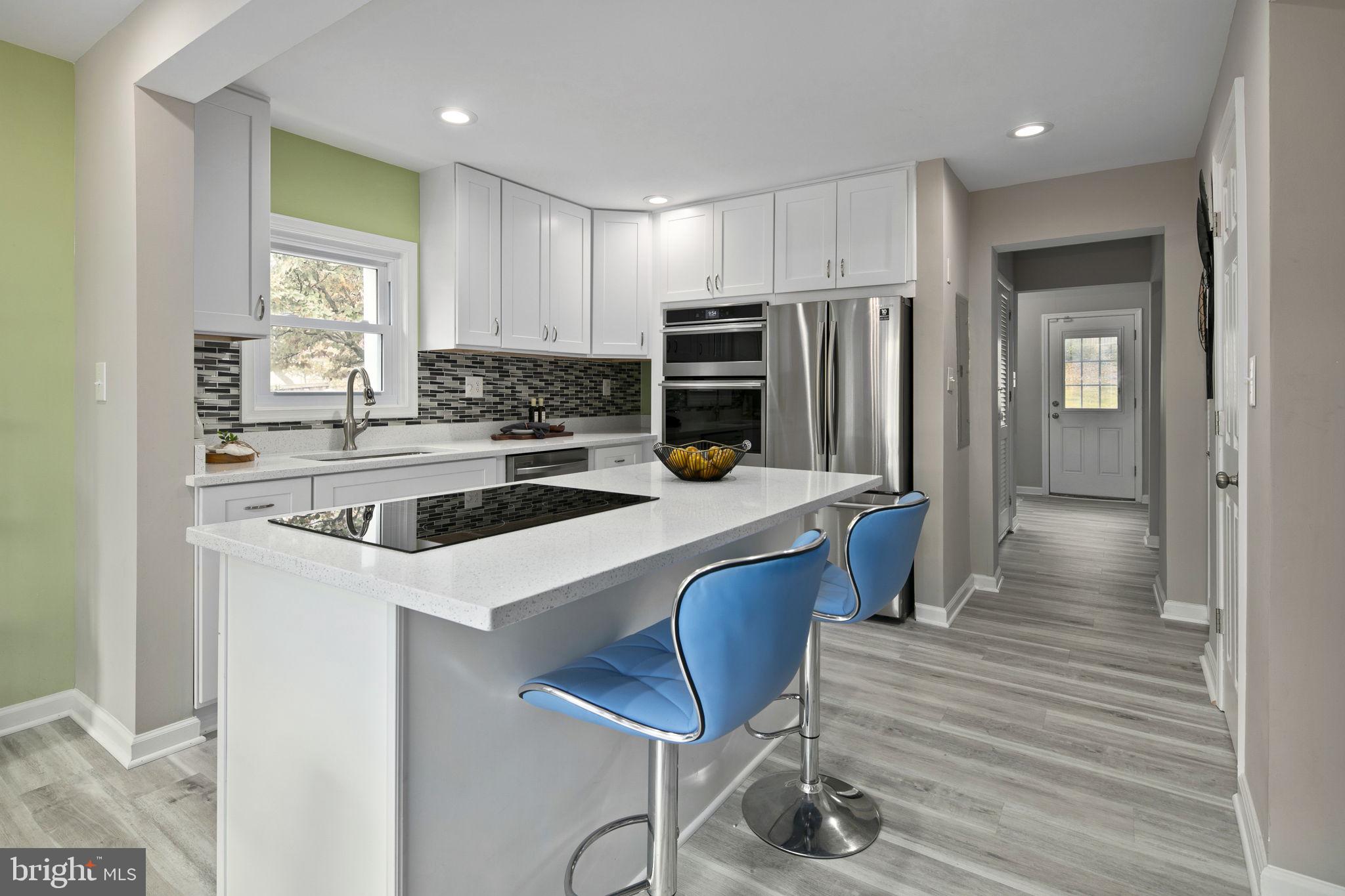 3424 Spring Drive Alexandria, VA 22306 - Photo 12 of 52 a kitchen with stainless steel appliances a stove a refrigerator and a refrigerator with wooden floor