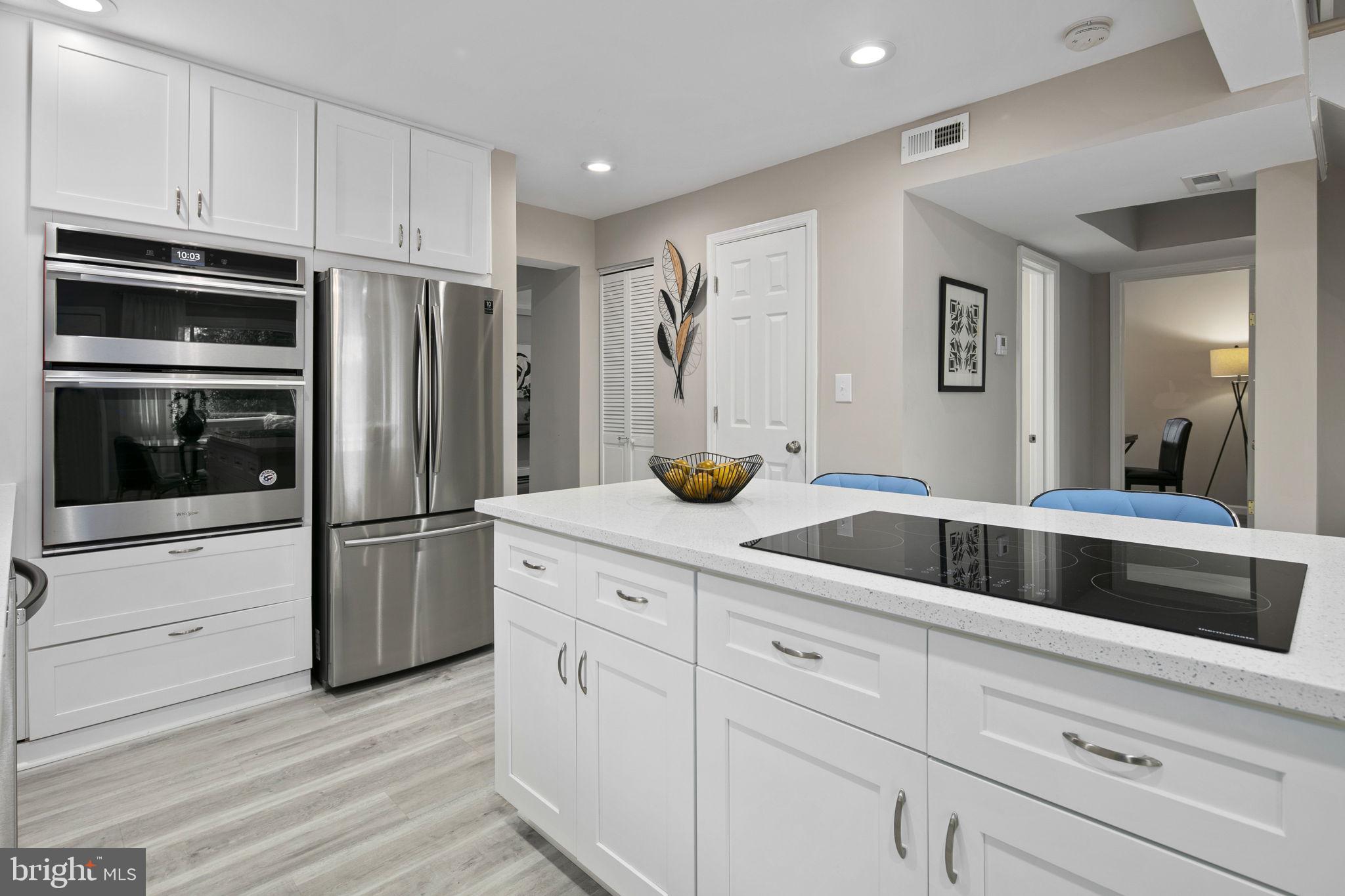 3424 Spring Drive Alexandria, VA 22306 - Photo 17 of 52 a kitchen with white cabinets and stainless steel appliances