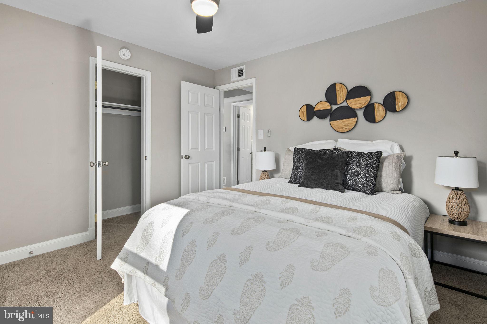 3424 Spring Drive Alexandria, VA 22306 - Photo 34 of 52 a bedroom with a bed and painting on the wall