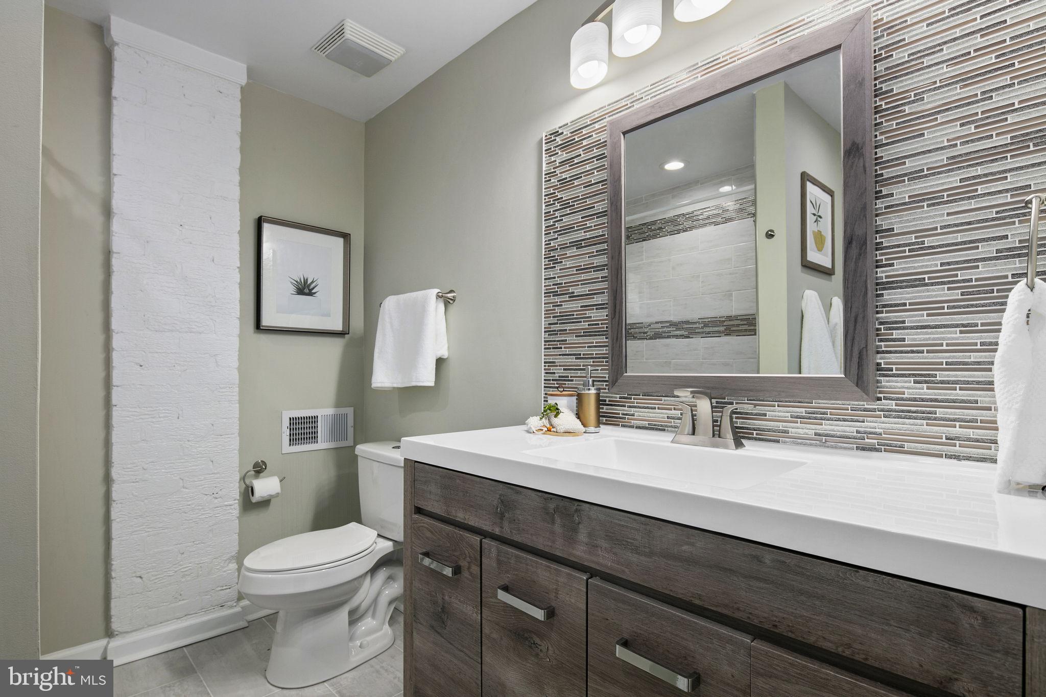 3424 Spring Drive Alexandria, VA 22306 - Photo 40 of 52 a bathroom with a sink a toilet a mirror and vanity