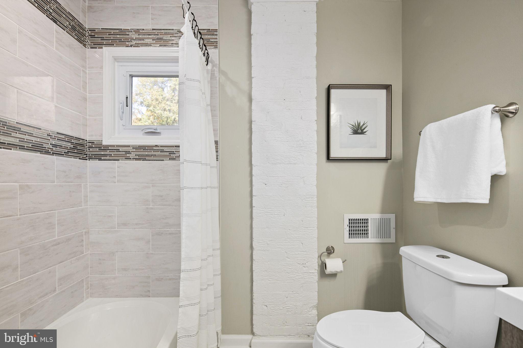 3424 Spring Drive Alexandria, VA 22306 - Photo 41 of 52 a white toilet sitting next to a bath tub