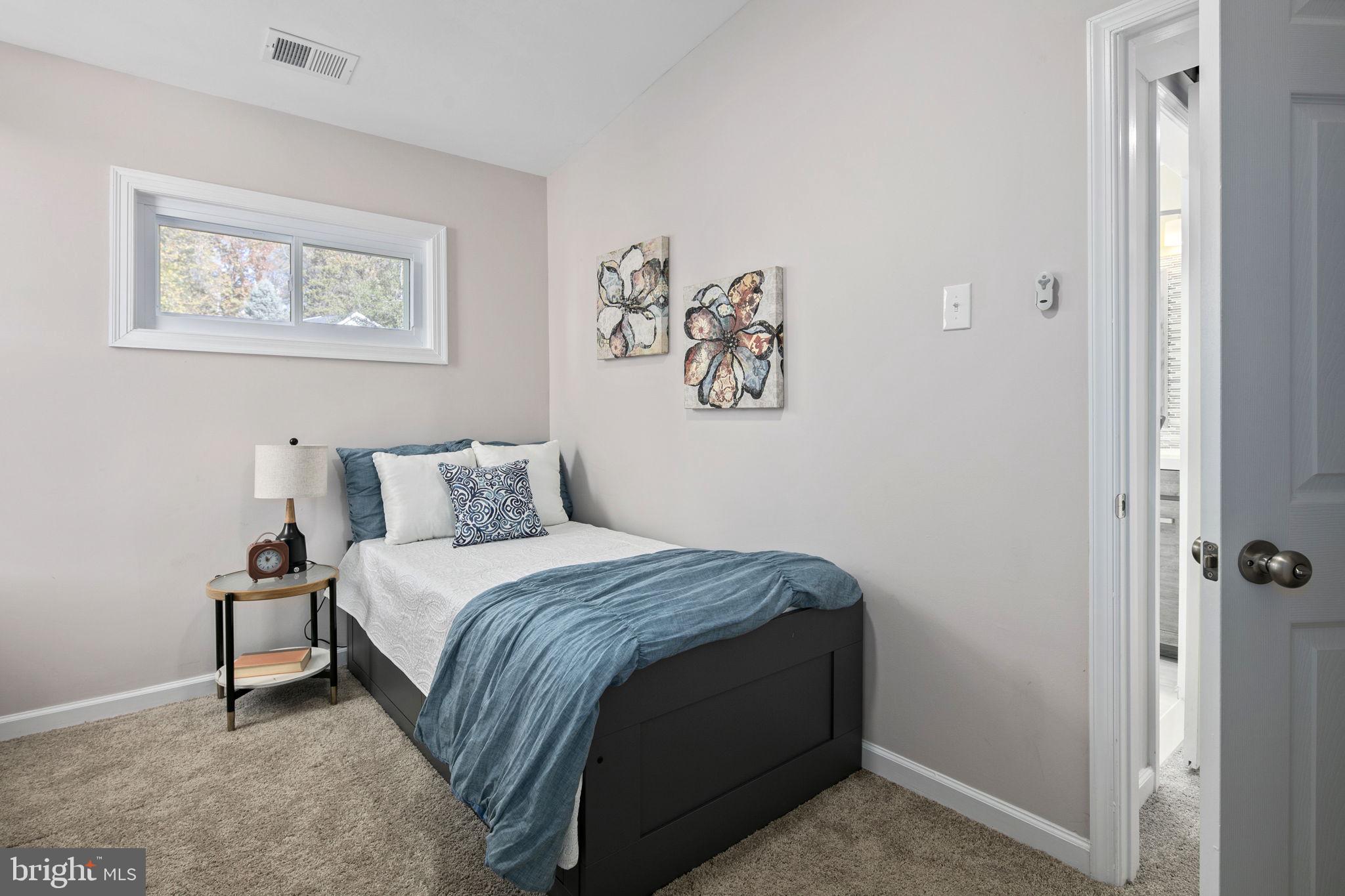 3424 Spring Drive Alexandria, VA 22306 - Photo 43 of 52 a bedroom with a bed and a wall painting