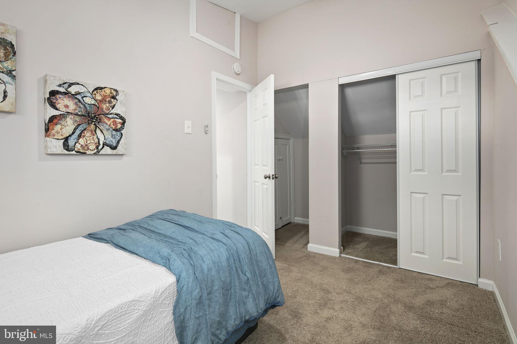 3424 Spring Drive Alexandria, VA 22306 - Photo 44 of 52 a bedroom with a bed and painting on the wall