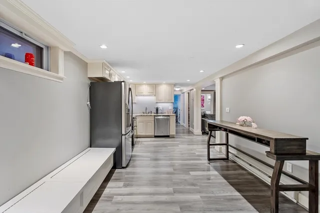 a kitchen with refrigerator cabinets and wooden floor