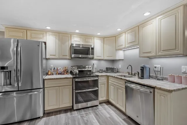 a kitchen with a sink and steel stainless steel appliances