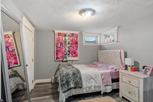 a bedroom with a bed and a mirror