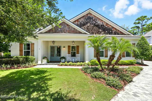 a front view of a house with swimming pool and porch with furniture