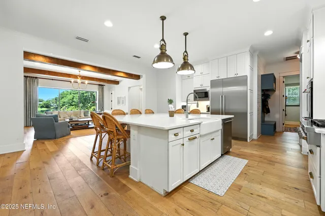 a kitchen with stainless steel appliances granite countertop a refrigerator and a stove