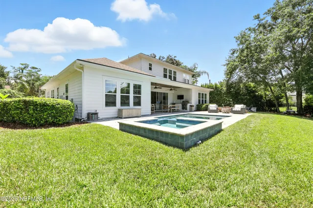a view of a garden with lawn chairs