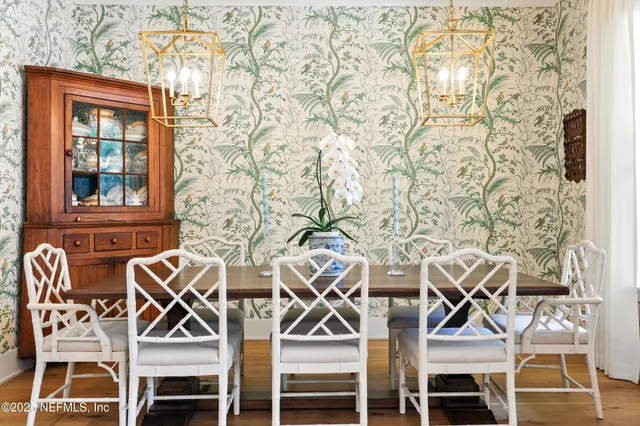 a kitchen with stainless steel appliances kitchen island granite countertop a dining table chairs and granite counter tops