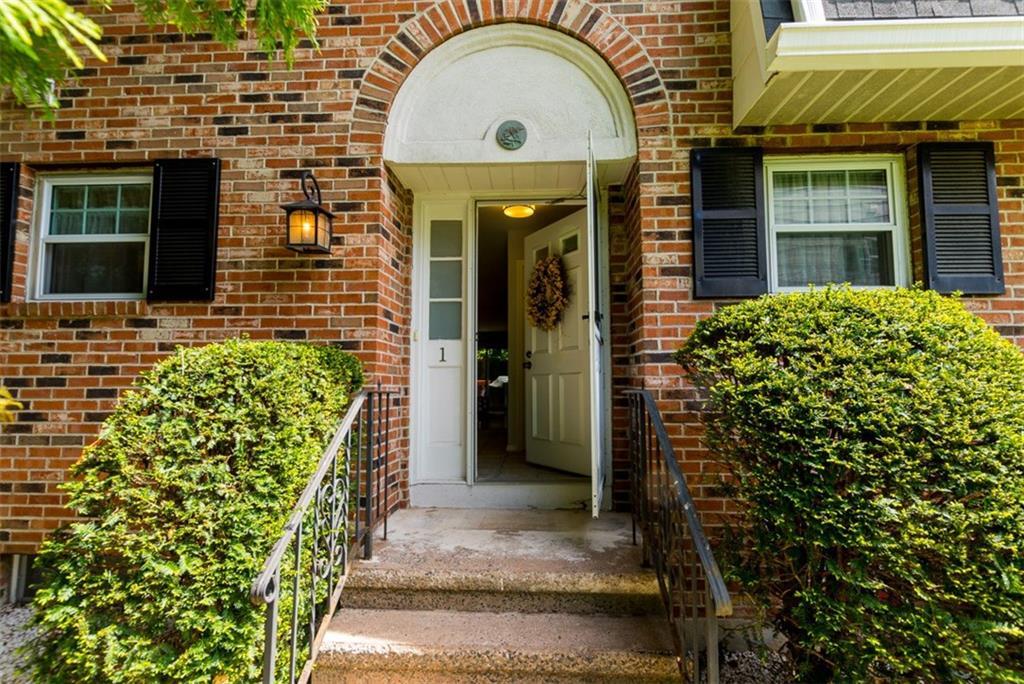 19 Colonial Road, Unit 1 Stamford, CT 06906 - Photo 1 of 1 a view of a brick house with a large windows