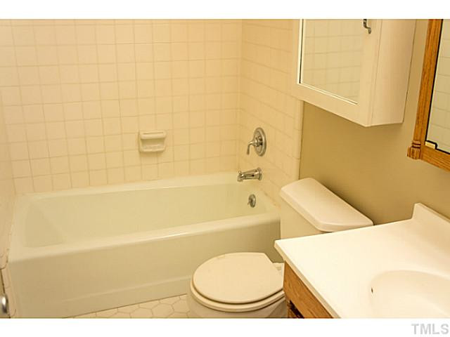 5814 Shady Grove Circle Raleigh, NC 27609 - Photo 13 of 15 a bathroom with a toilet and a bathtub