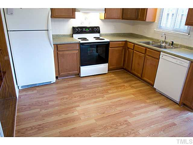 5814 Shady Grove Circle Raleigh, NC 27609 - Photo 4 of 15 a kitchen with stainless steel appliances a stove a sink and a refrigerator