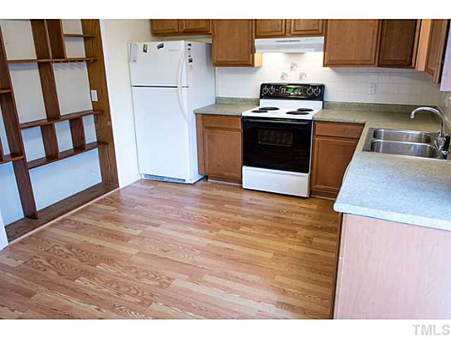 5814 Shady Grove Circle Raleigh, NC 27609 - Photo 5 of 15 a kitchen with granite countertop a stove and a refrigerator