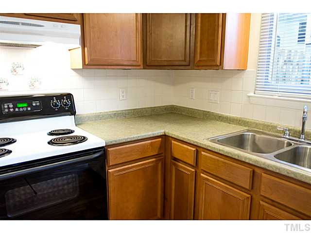 5814 Shady Grove Circle Raleigh, NC 27609 - Photo 6 of 15 a kitchen with a sink a stove and cabinets