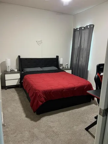 a bedroom with a bed and a dresser