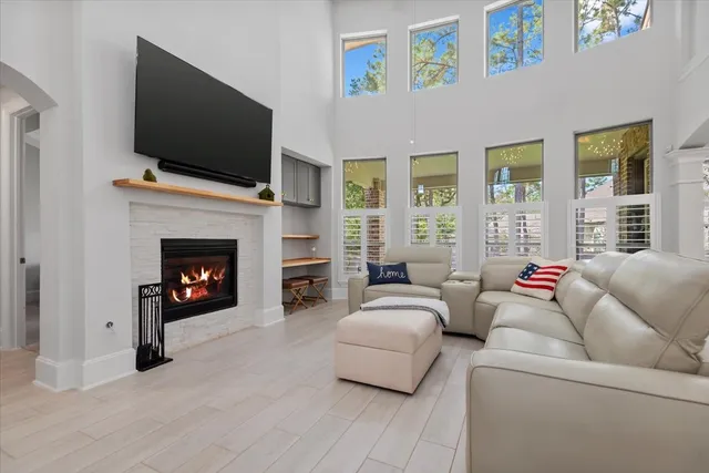 a living room with furniture a flat screen tv and a fireplace