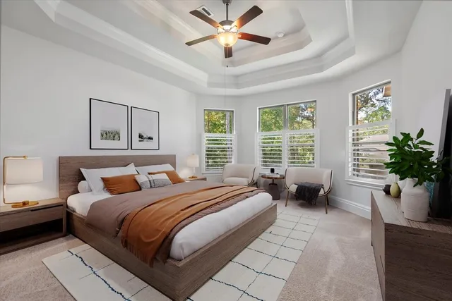 a bedroom with bed and a chandelier
