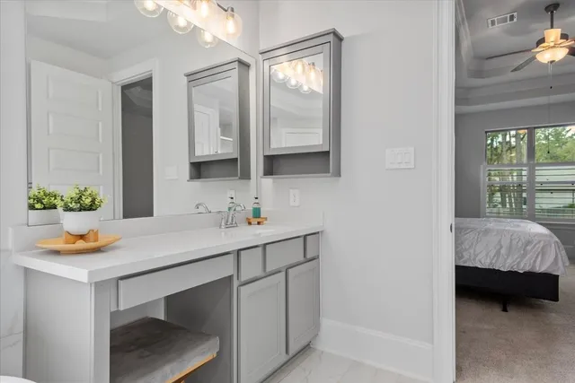 a en suite bathroom with a sink and a mirror