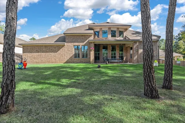 a view of a house with a yard and sitting area