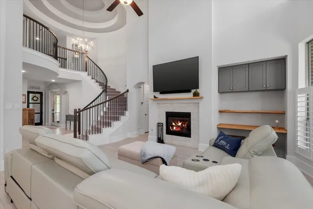 a living room with furniture a fireplace and a flat screen tv