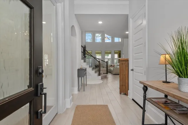 a hallway with a dining table wooden floor and a rug
