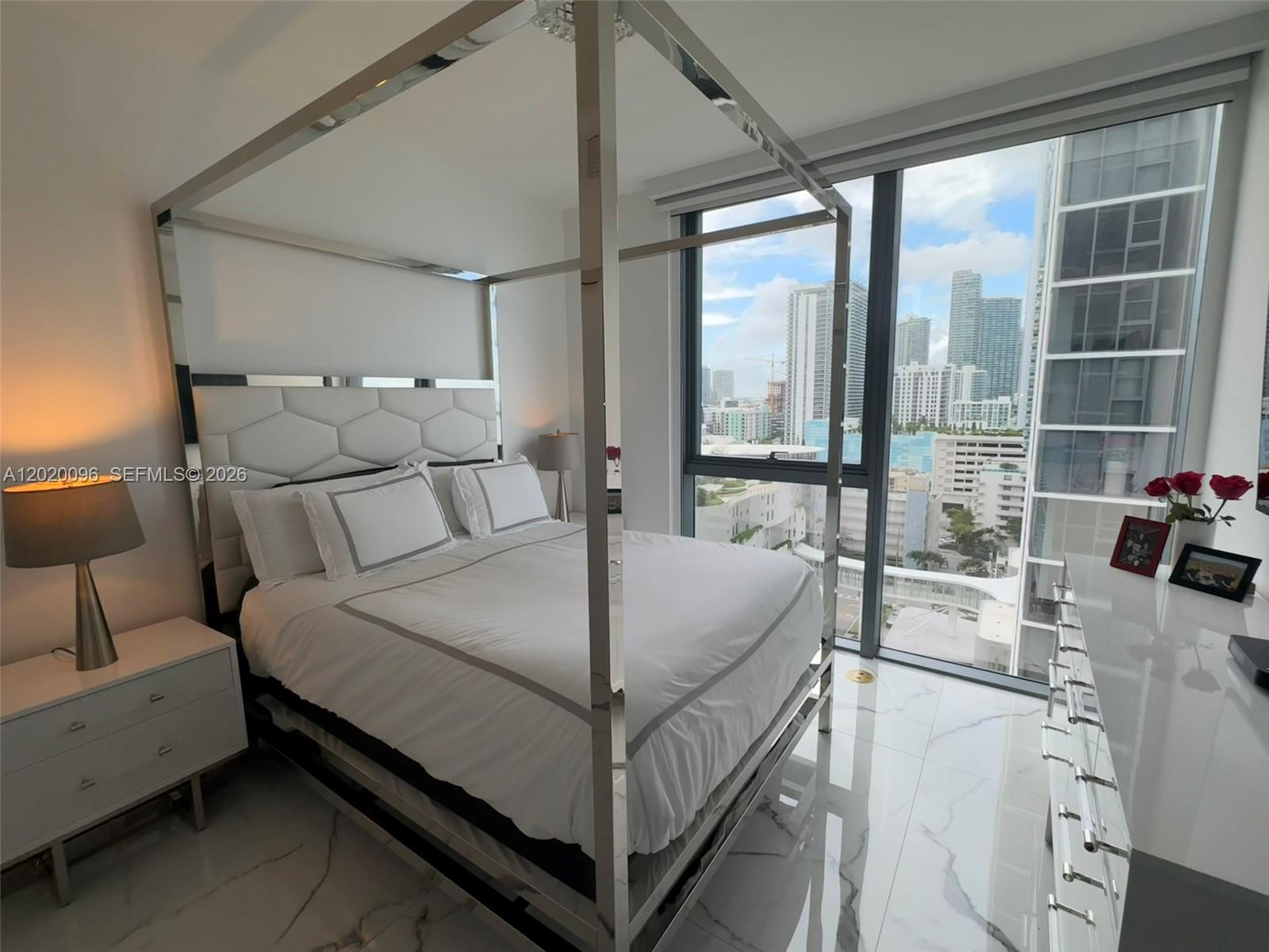 788 Northeast 23rd Street, Unit 1202 Miami, FL 33137 - Photo 33 of 64 a bed room with a bed and a large window