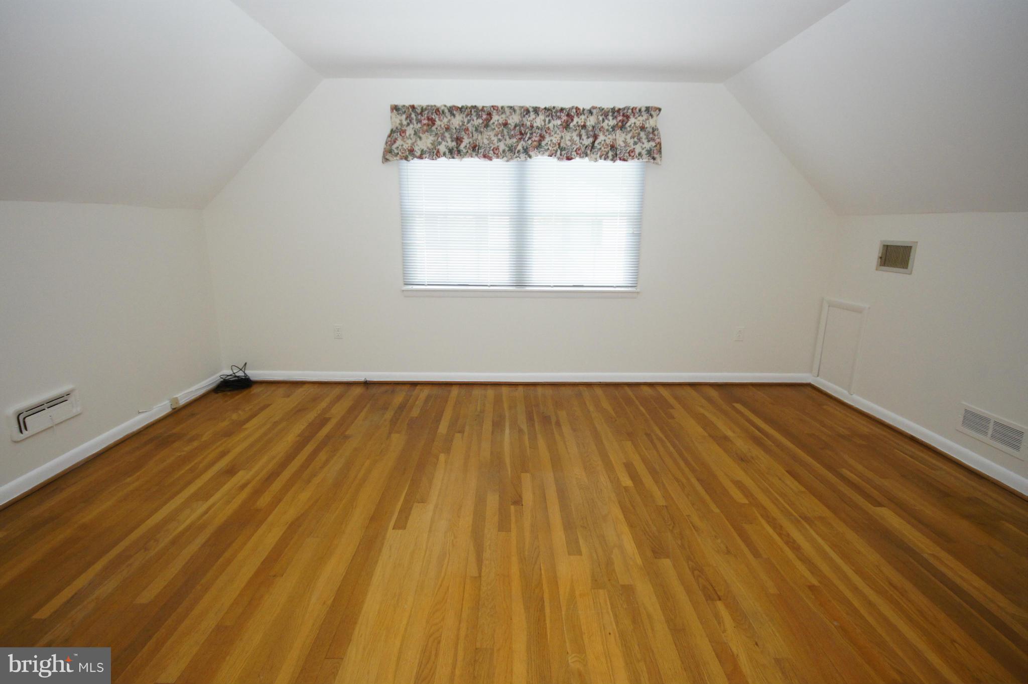 6202 Gilston Park Road Baltimore, MD 21228 - Photo 11 of 21 a view of a room with wooden floor and front door
