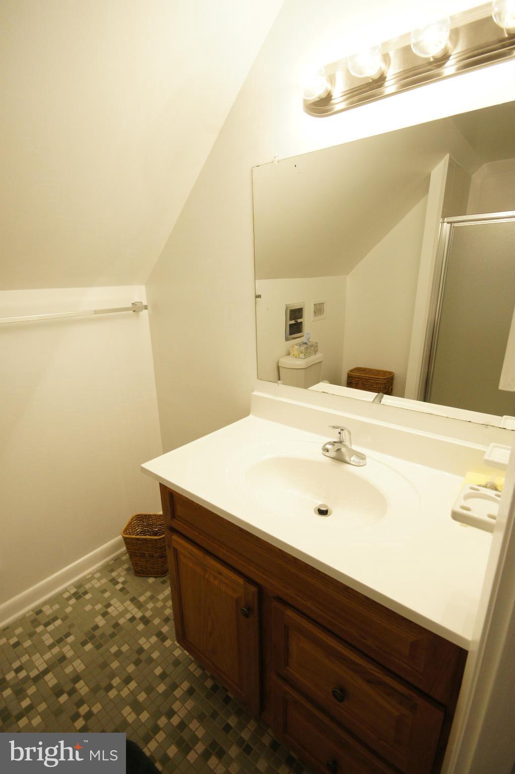 6202 Gilston Park Road Baltimore, MD 21228 - Photo 13 of 21 a bathroom with a sink and a mirror