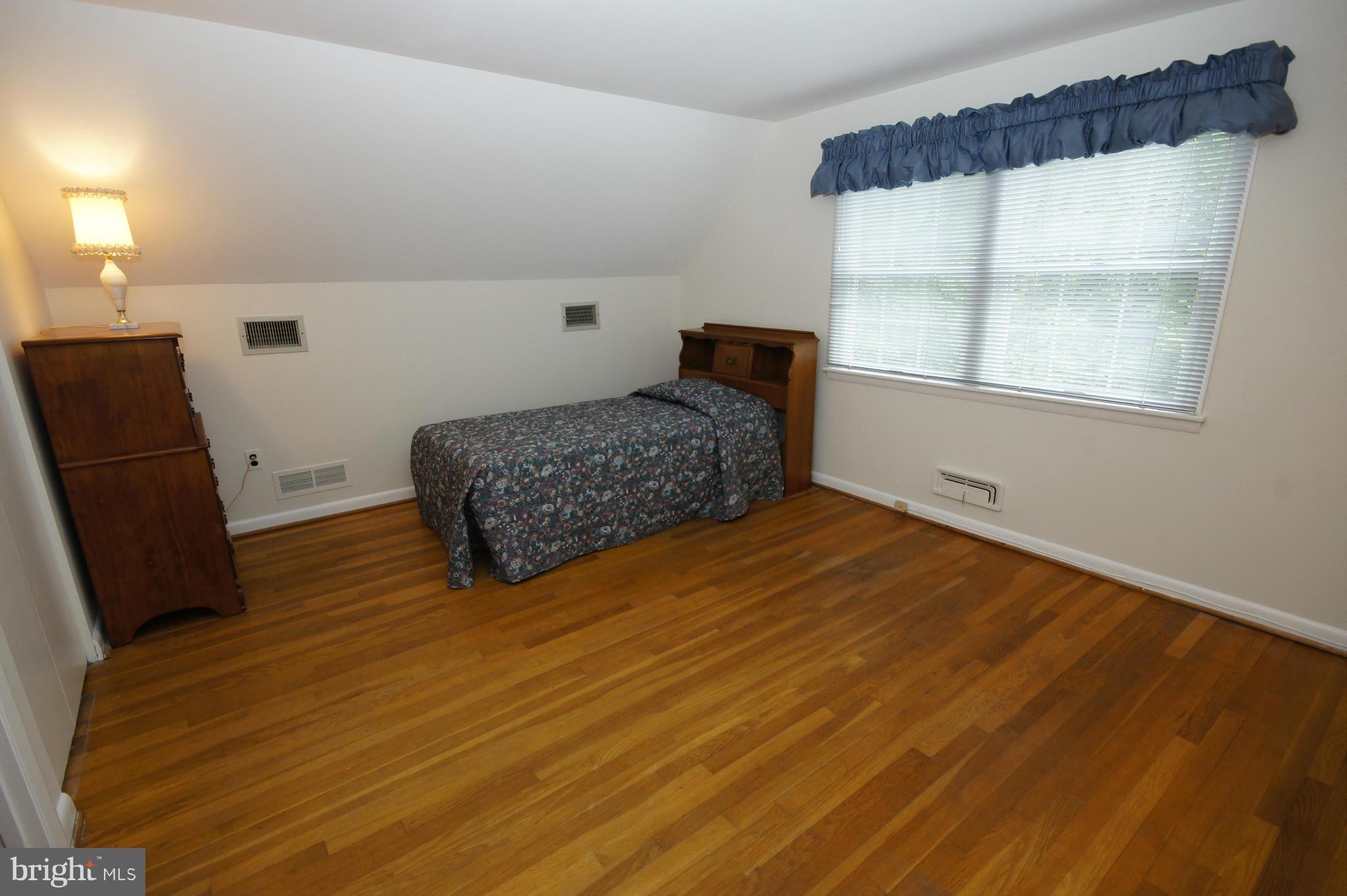 6202 Gilston Park Road Baltimore, MD 21228 - Photo 9 of 21 a bedroom with a bed and a window
