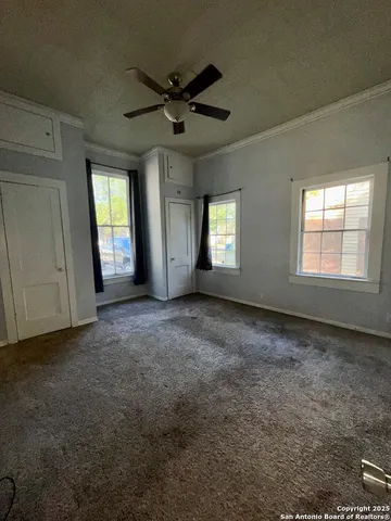 a view of a livingroom with a ceiling fan and window