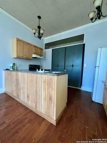 a view of a kitchen with a sink and dishwasher wooden floor