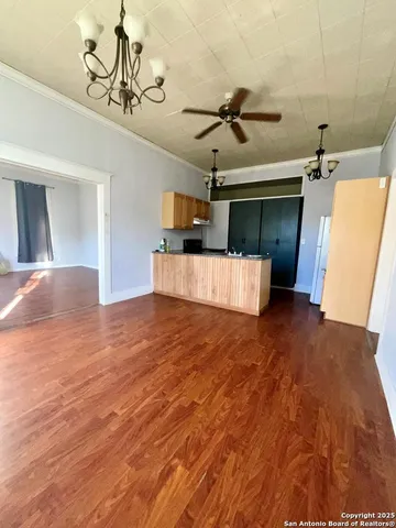 a view of a kitchen with a sink and wooden floor